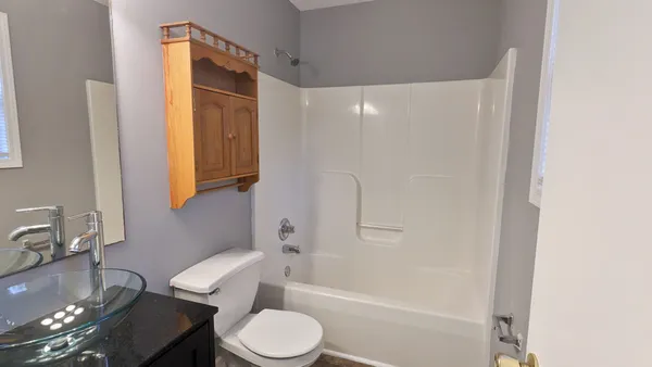 a bathroom with a toilet a sink and bathtub
