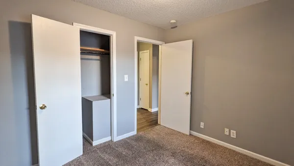 a bathroom with a granite countertop bathtub shower sink and toilet