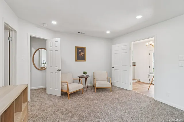 a living room with furniture a air conditioner vent and a window