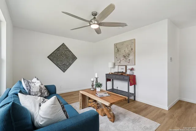 a living room with furniture and a wooden floor
