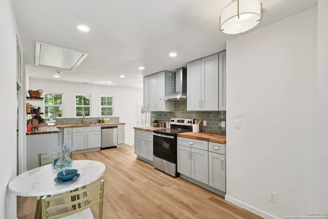 a kitchen with a sink stainless steel appliances and cabinets