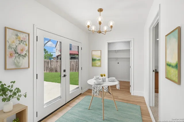 a outdoor dining space with furniture wooden floor a rug a potted plant and a chandelier