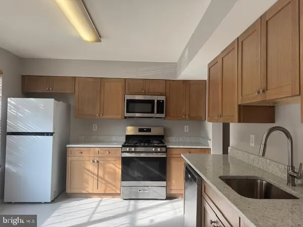 a kitchen with a sink a stove and refrigerator