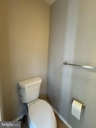 a white toilet sitting next to a white sink and vanity