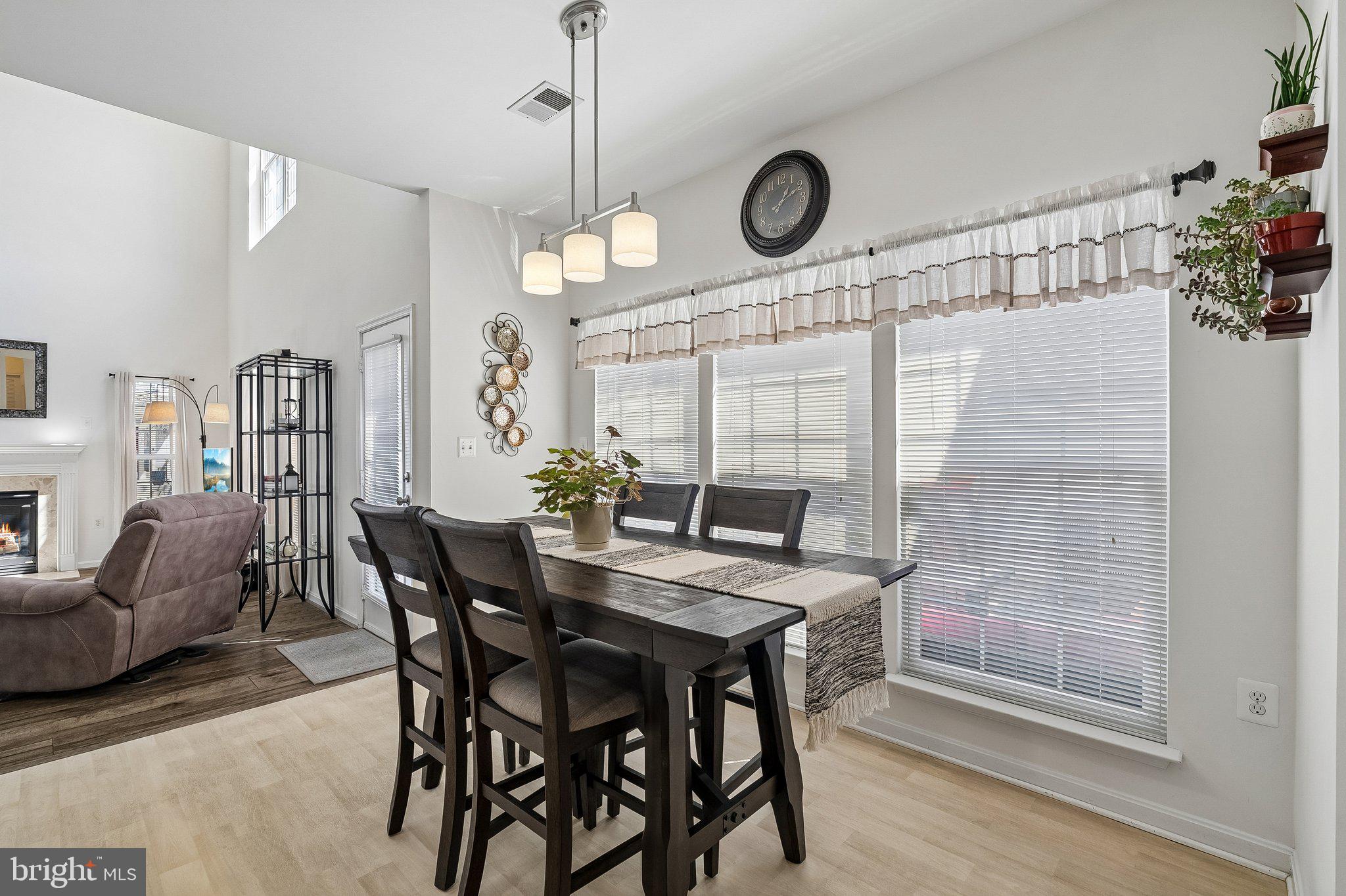 43351 Fullerton Street Ashburn, VA 20147 - Photo 12 of 41 a view of a dining room and livingroom furniture wooden floor a chandelier a wooden table and chairs