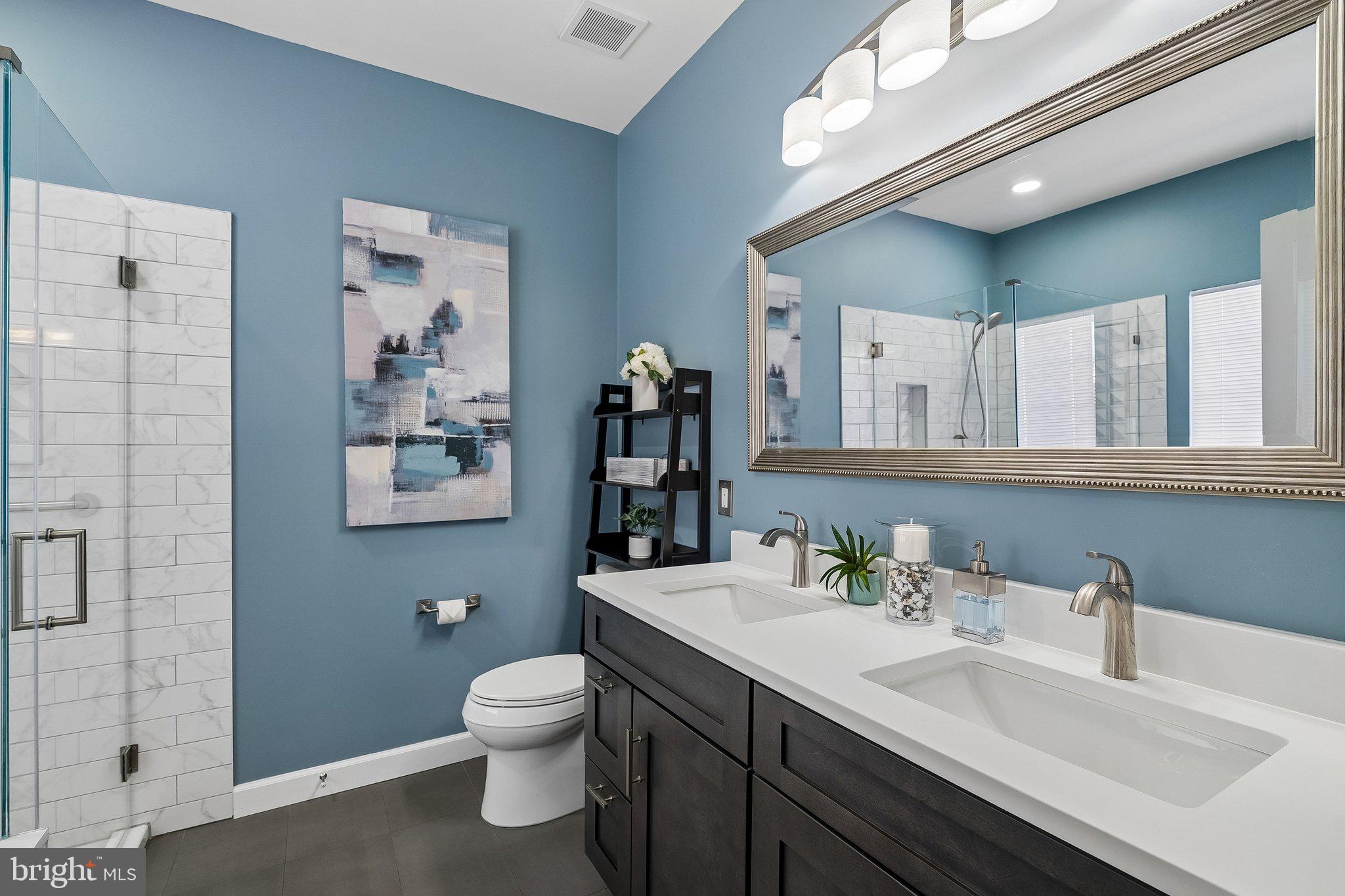 43351 Fullerton Street Ashburn, VA 20147 - Photo 20 of 41 a bathroom with a toilet sink and mirror