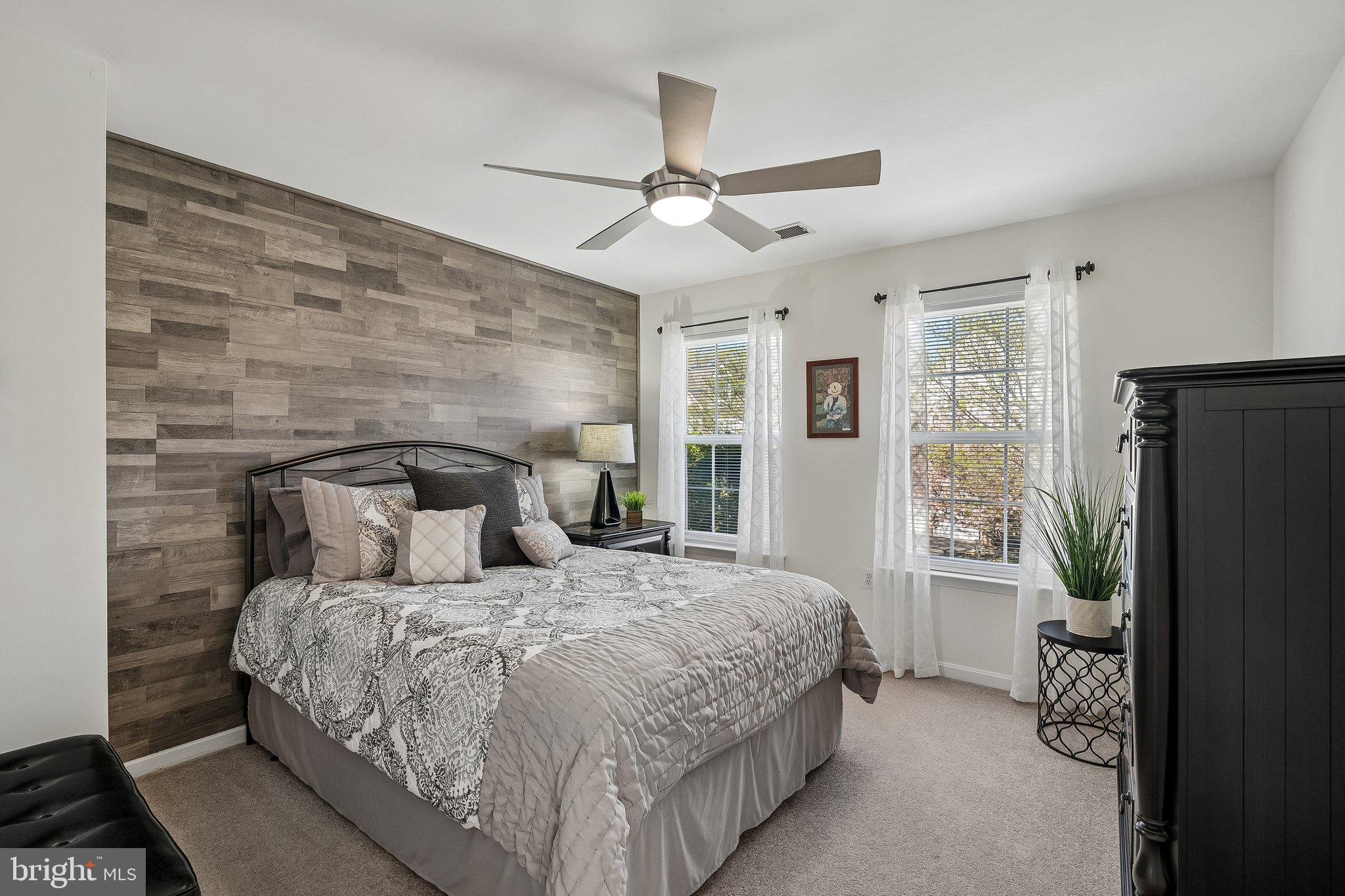 43351 Fullerton Street Ashburn, VA 20147 - Photo 23 of 41 a bedroom with a bed large window and a flat tv screen