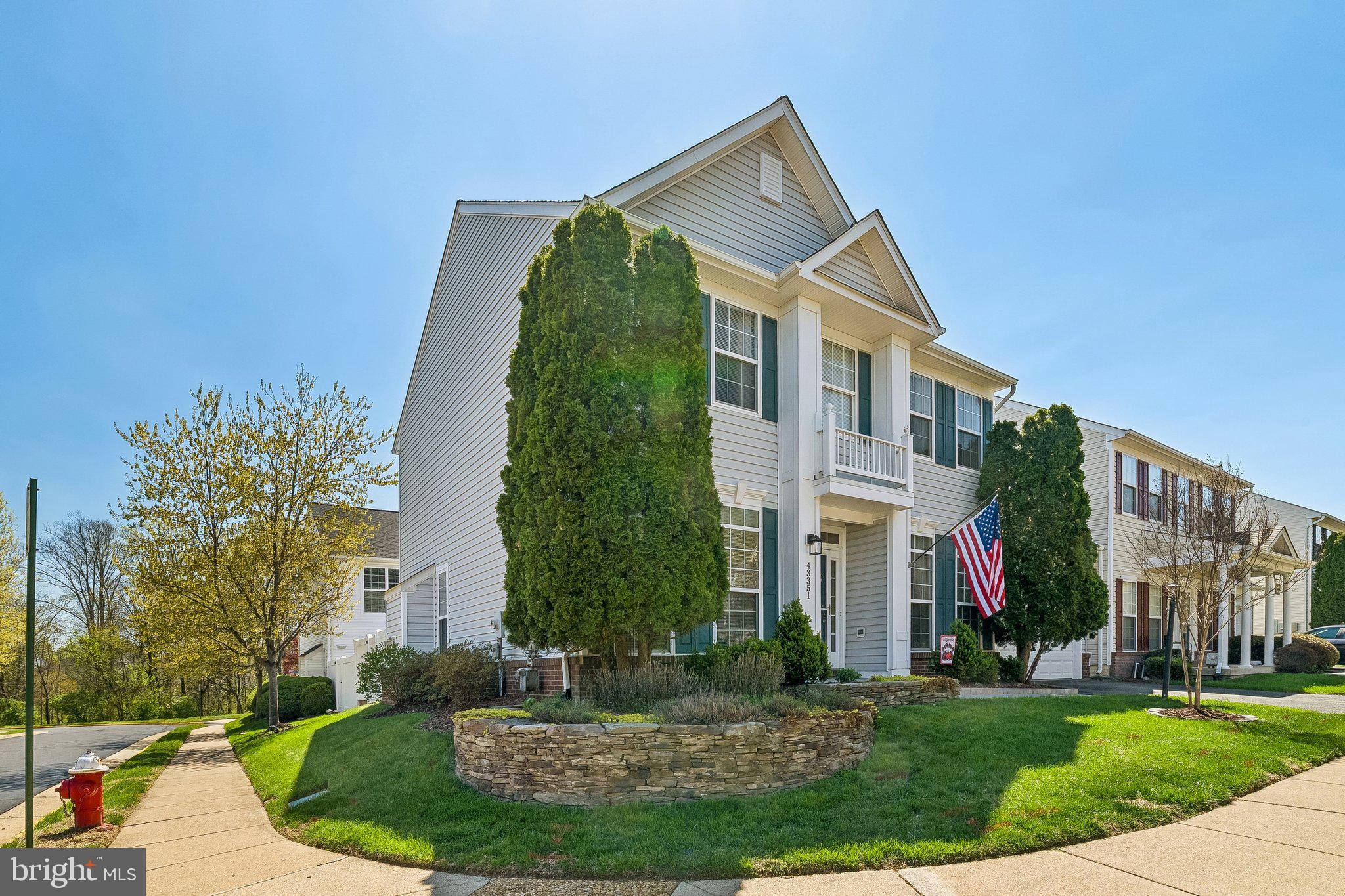 43351 Fullerton Street Ashburn, VA 20147 - Photo 32 of 41 a view of a white house next to a yard with plants and trees