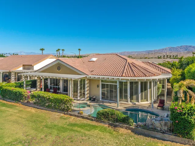 a front view of a house with a yard table and chairs