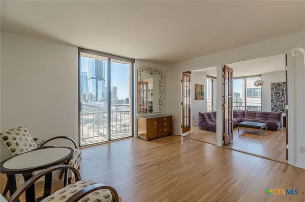 a living room with furniture and wooden floor