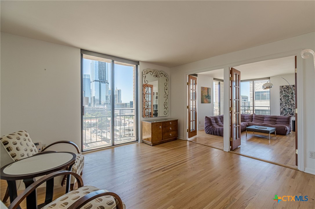 1122 Colorado Street, Unit 1409 Austin, TX 78701 - Photo 20 of 32 a living room with furniture and wooden floor