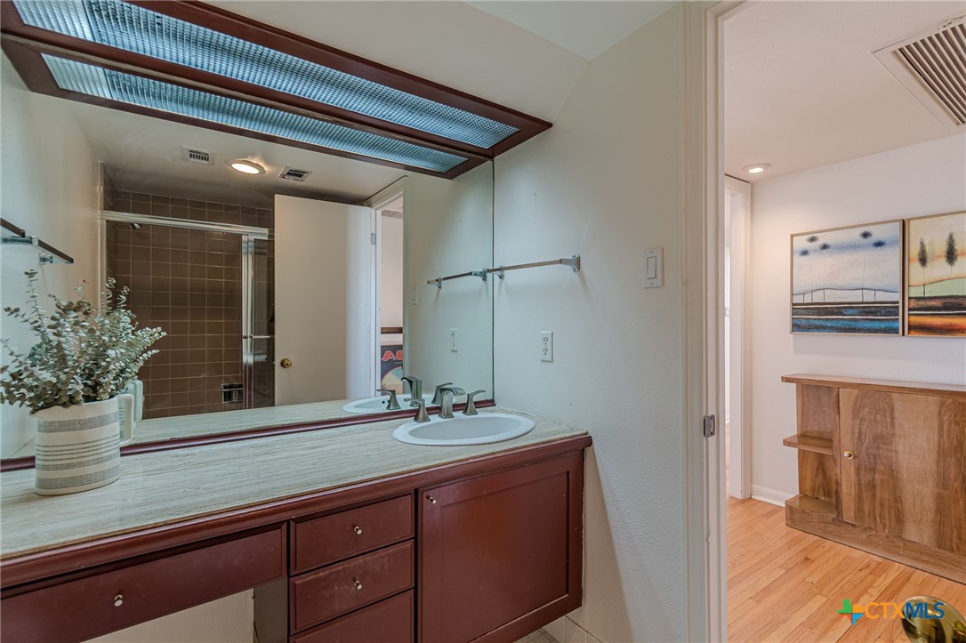 1122 Colorado Street, Unit 1409 Austin, TX 78701 - Photo 22 of 32 a bathroom with a sink and a mirror