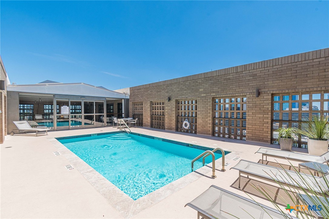 1122 Colorado Street, Unit 1409 Austin, TX 78701 - Photo 25 of 32 a view of a house with swimming pool and porch with furniture
