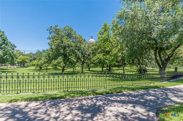 a view of a park with a large trees