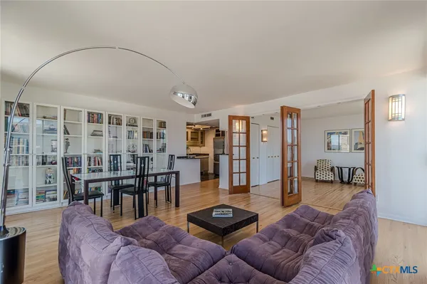 a living room with furniture and wooden floor