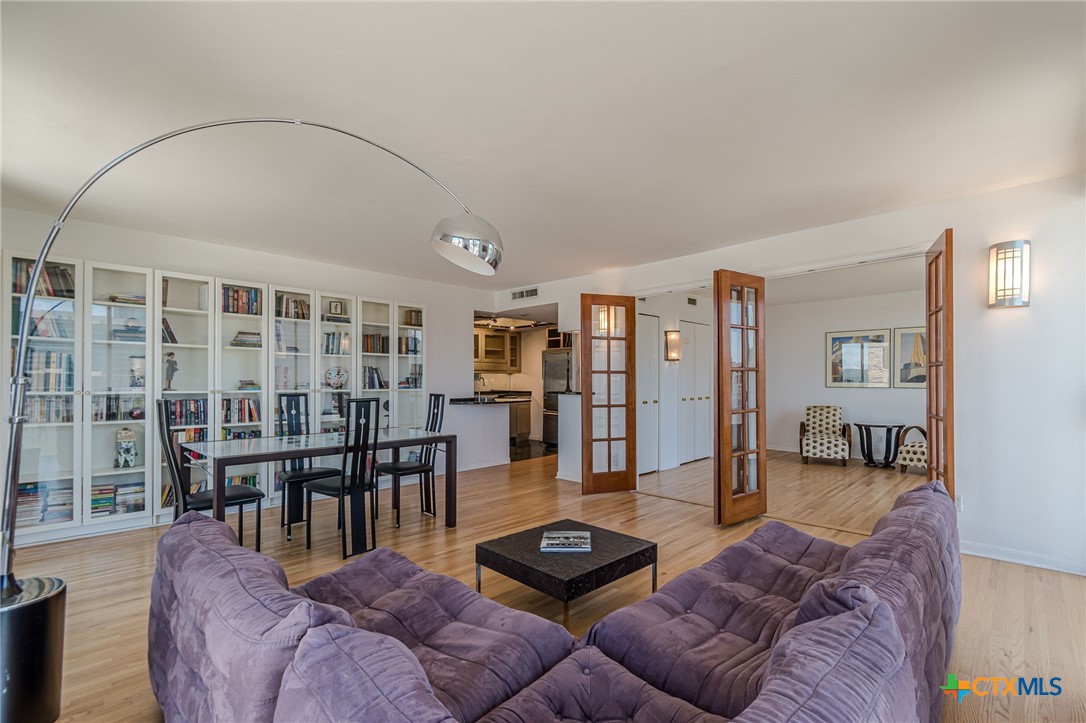1122 Colorado Street, Unit 1409 Austin, TX 78701 - Photo 5 of 32 a living room with furniture and wooden floor