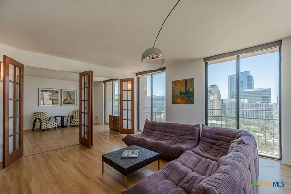 a living room with furniture and a floor to ceiling window
