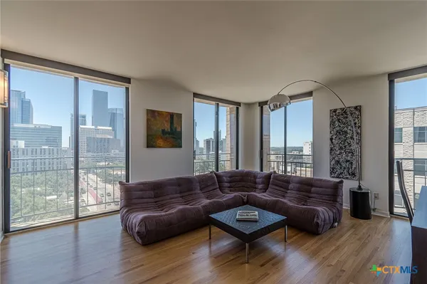 a living room with furniture and wooden floor