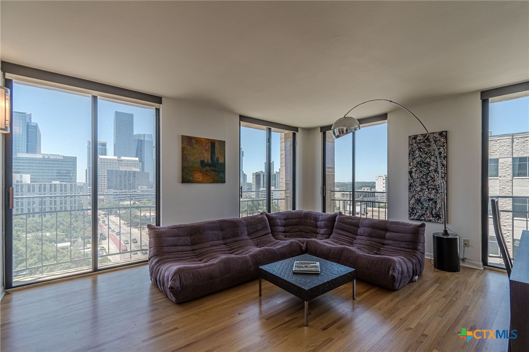 1122 Colorado Street, Unit 1409 Austin, TX 78701 - Photo 7 of 32 a living room with furniture and wooden floor