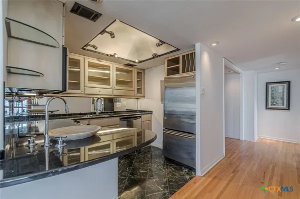 a kitchen with wooden cabinets and stainless steel appliances