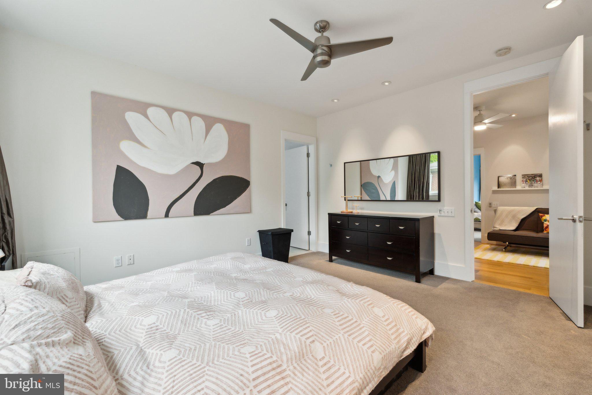 5929 Onondaga Road Bethesda, MD 20816 - Photo 17 of 47 a bedroom with a large bed and a mirror