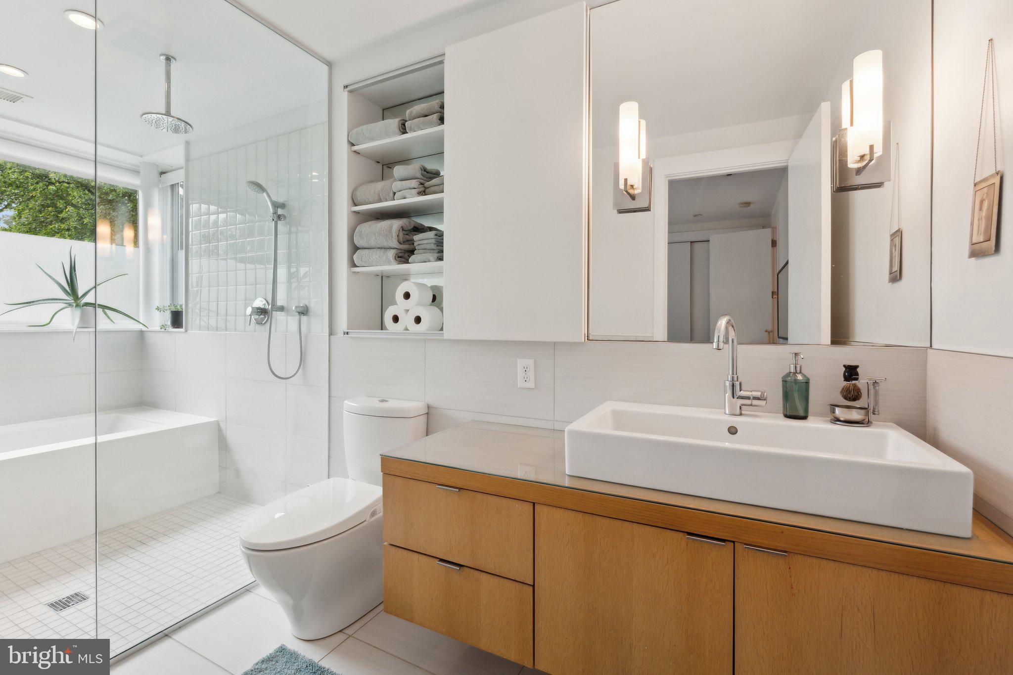 5929 Onondaga Road Bethesda, MD 20816 - Photo 18 of 47 a bathroom with a sink a toilet a mirror and shower