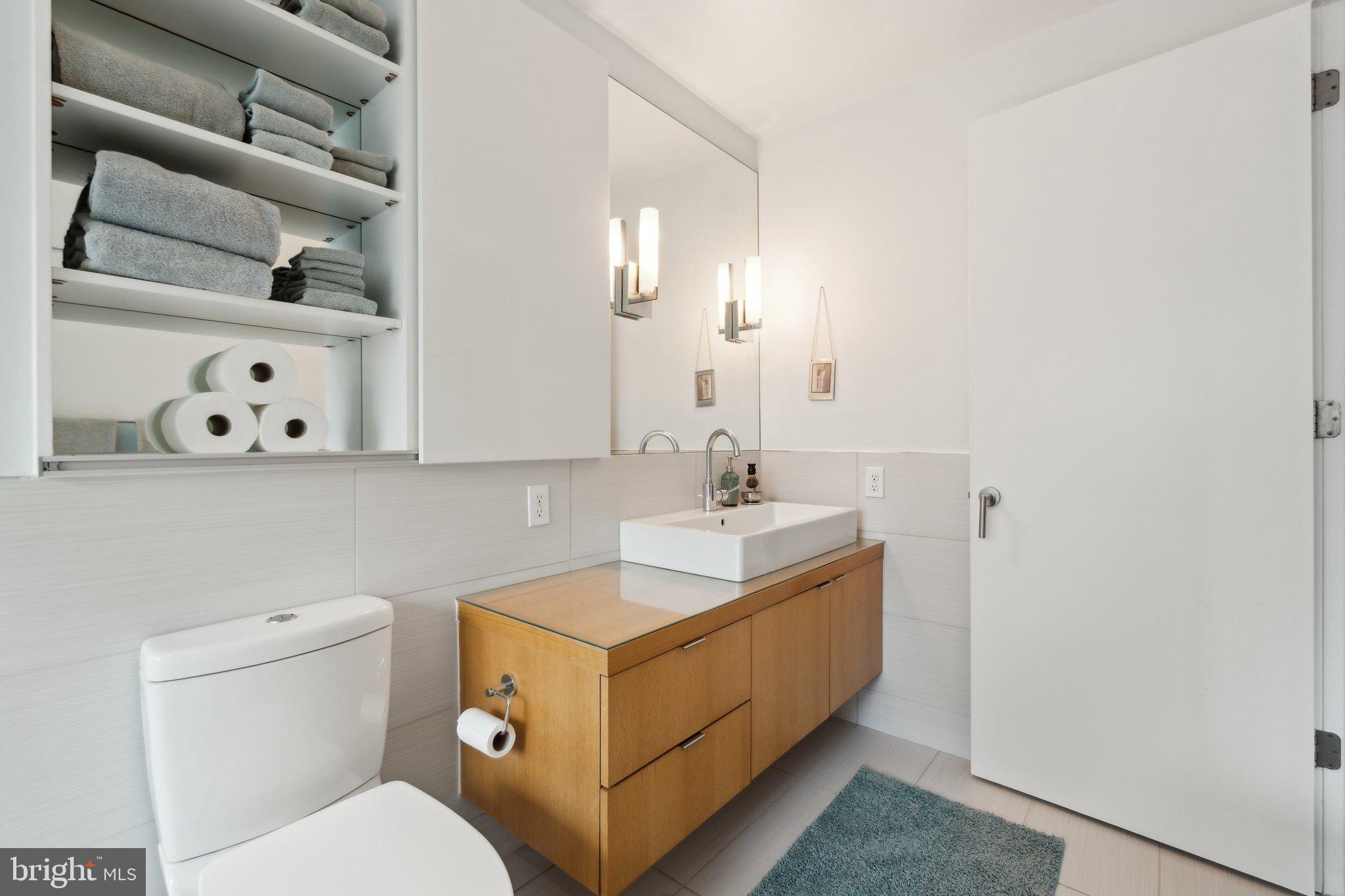 5929 Onondaga Road Bethesda, MD 20816 - Photo 20 of 47 a bathroom with a toilet sink and mirror