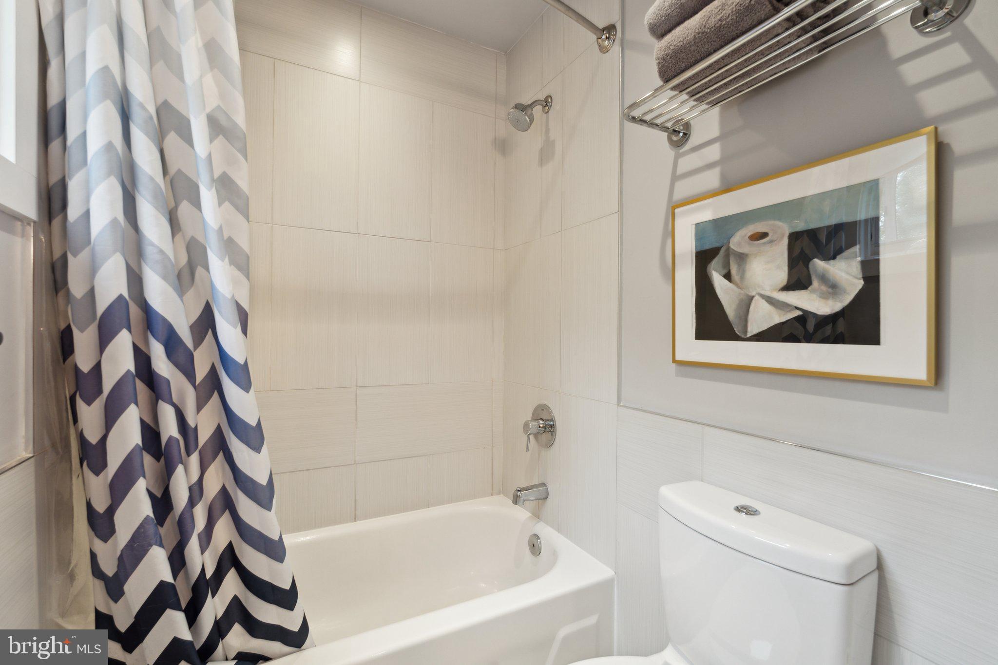 5929 Onondaga Road Bethesda, MD 20816 - Photo 23 of 47 a bathroom with a bathtub and shower