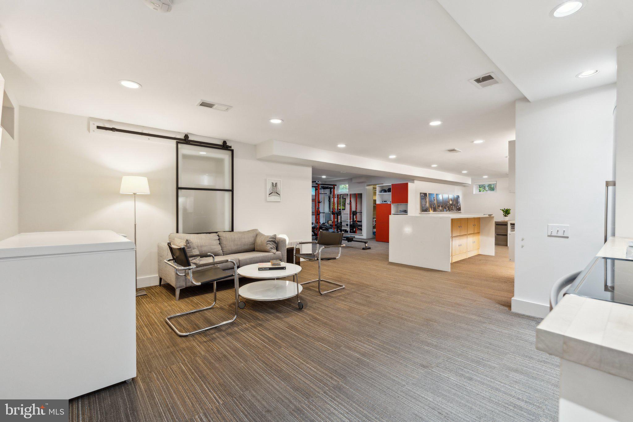 5929 Onondaga Road Bethesda, MD 20816 - Photo 28 of 47 a living room with furniture kitchen view and a wooden floor