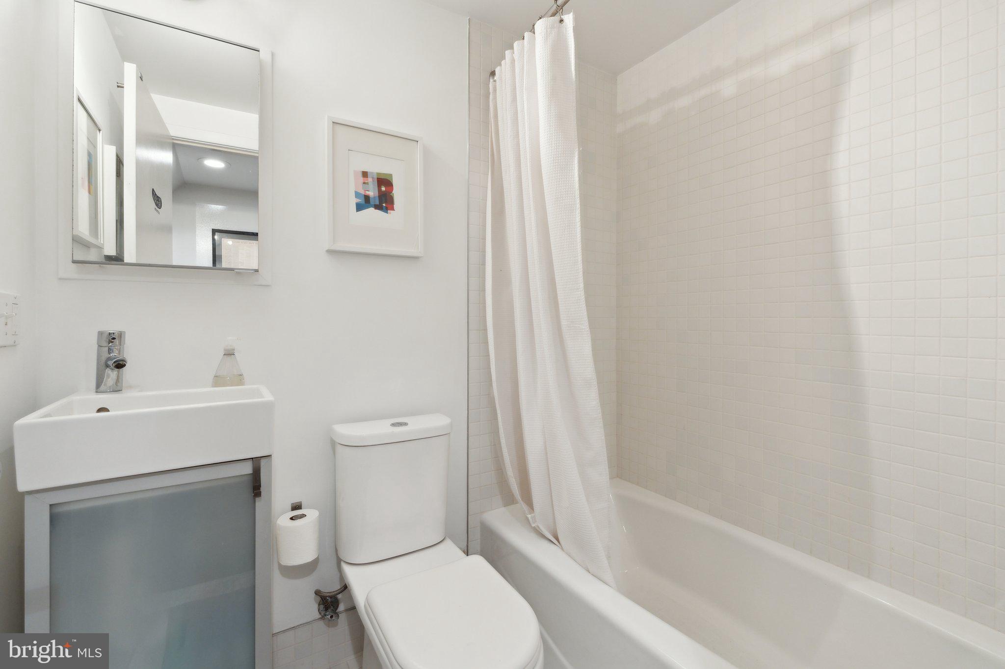 5929 Onondaga Road Bethesda, MD 20816 - Photo 32 of 47 a bathroom with a sink a toilet and shower
