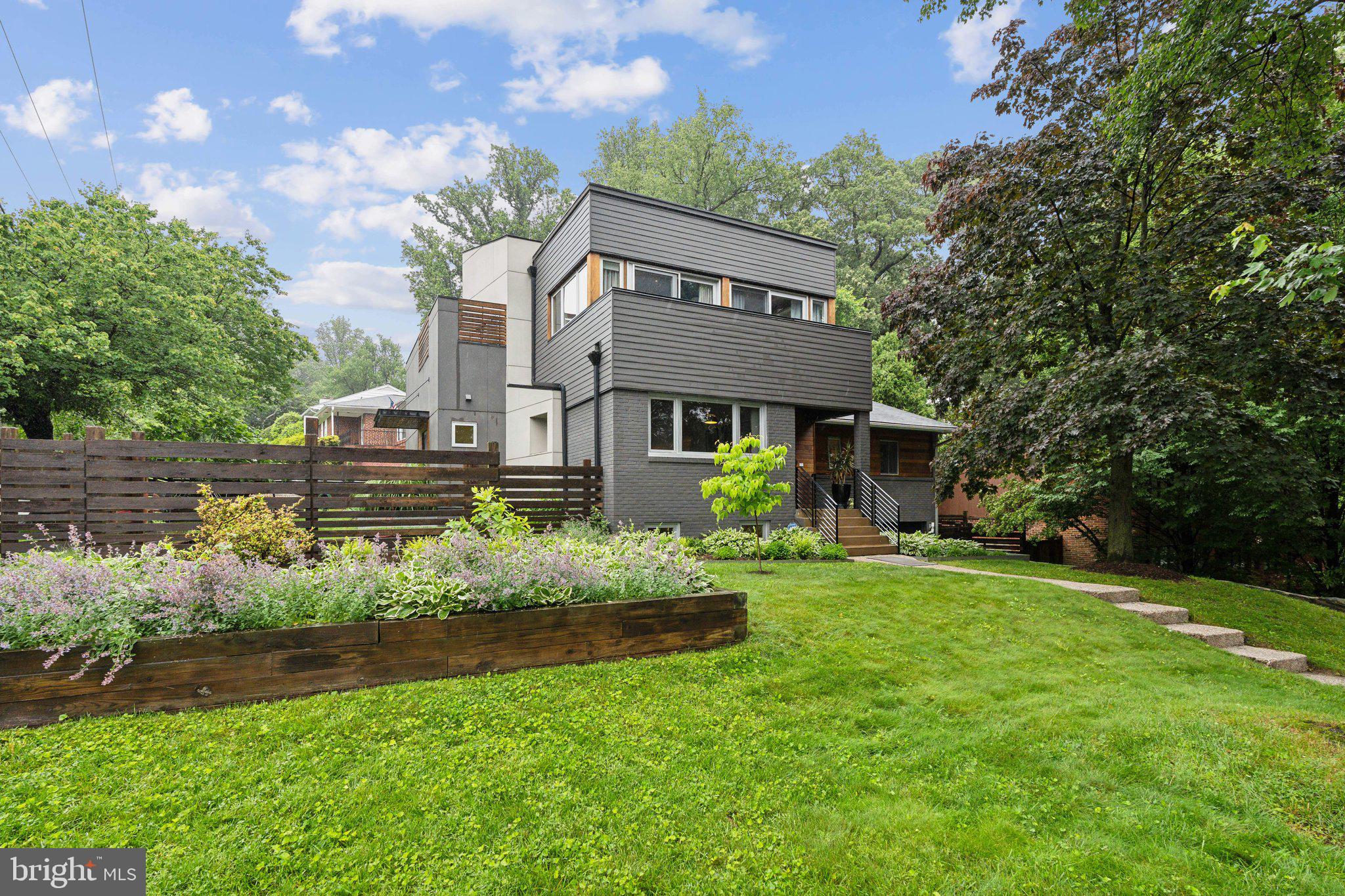 5929 Onondaga Road Bethesda, MD 20816 - Photo 41 of 47 a front view of a house with a garden and plants