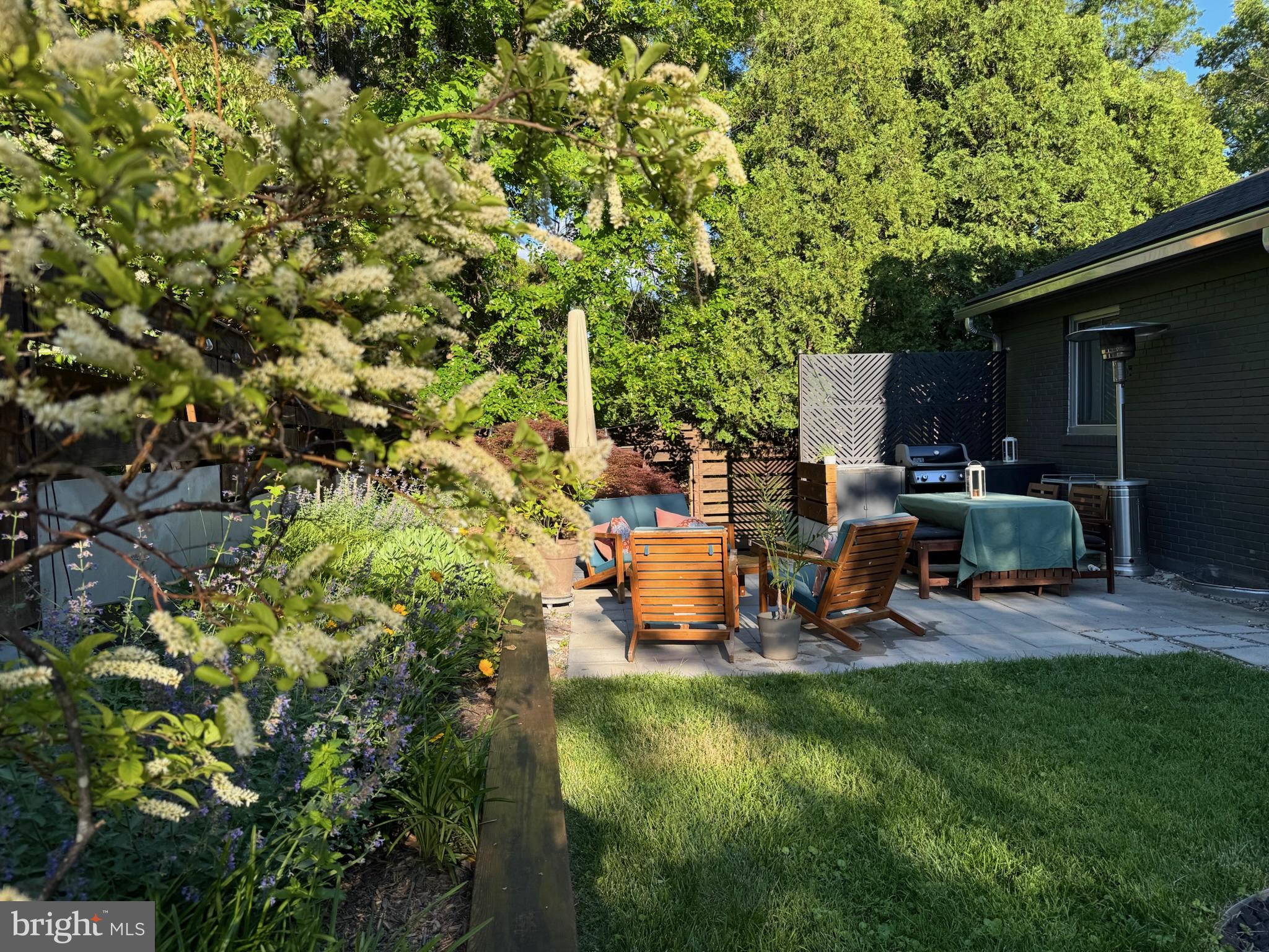 5929 Onondaga Road Bethesda, MD 20816 - Photo 46 of 47 a view of a backyard with table and chairs and a fire pit