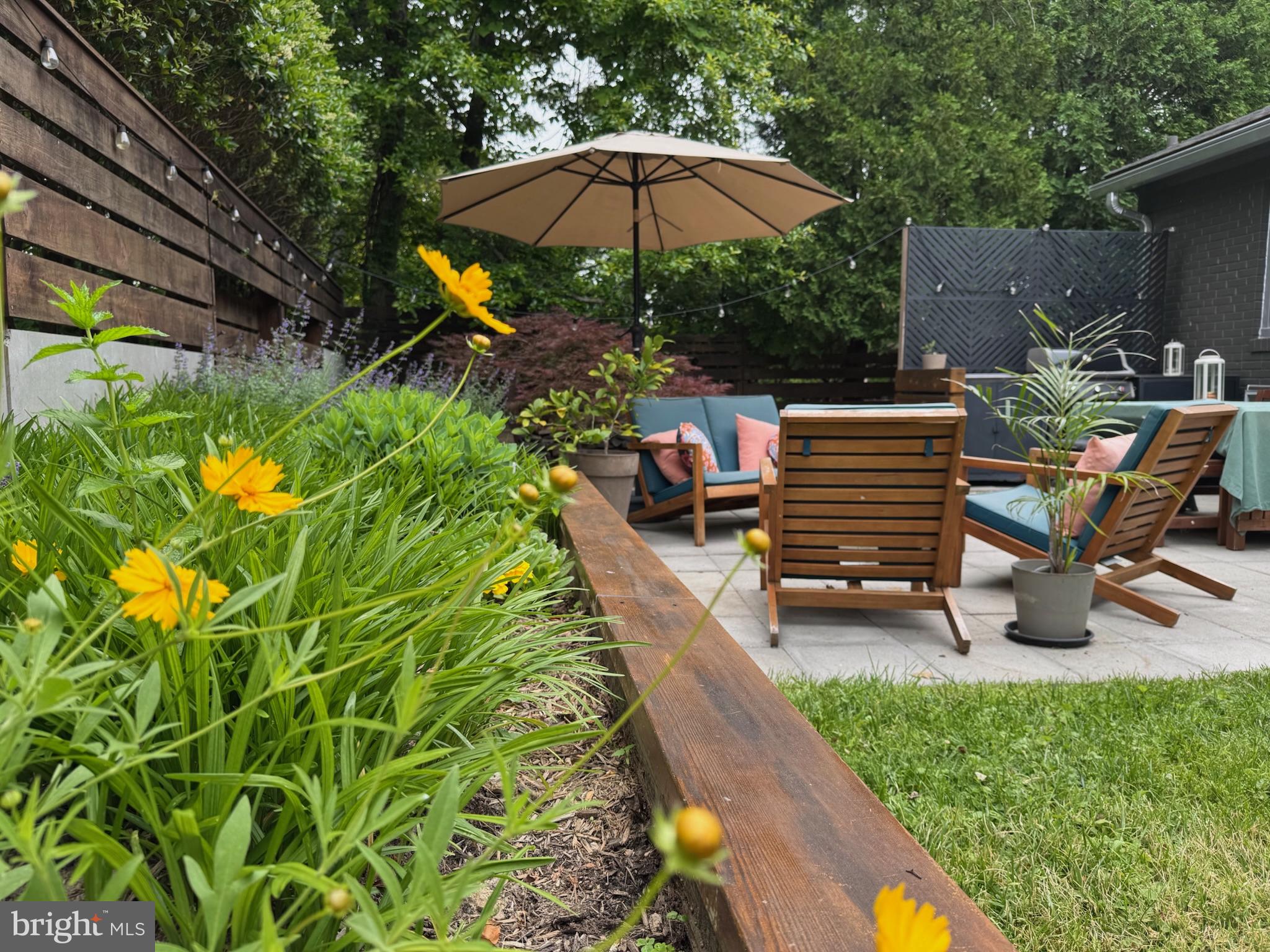 5929 Onondaga Road Bethesda, MD 20816 - Photo 47 of 47 a backyard of a house with table and chairs under an umbrella