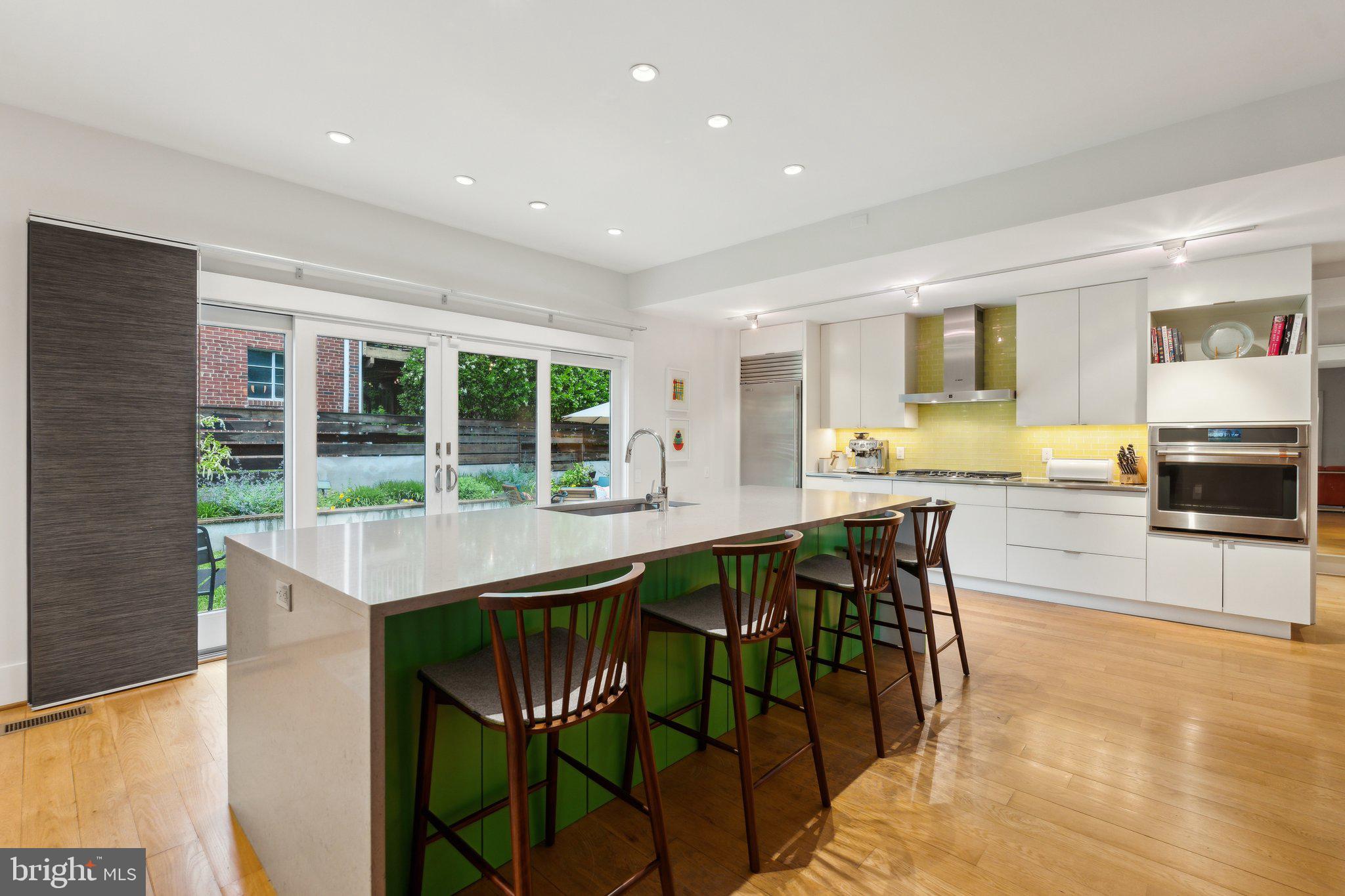 5929 Onondaga Road Bethesda, MD 20816 - Photo 8 of 47 a kitchen with stainless steel appliances granite countertop table chairs sink and cabinets