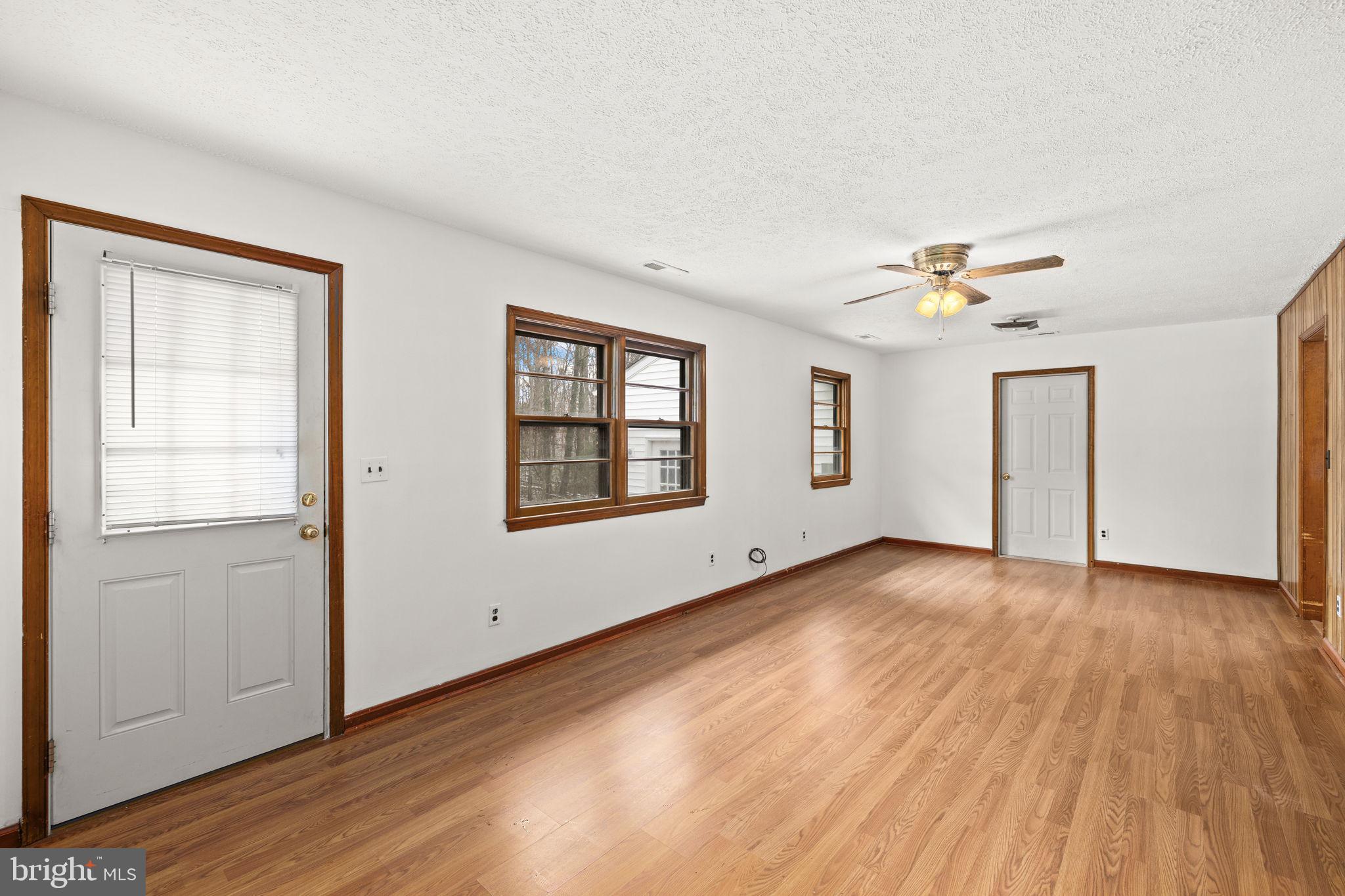 11604 Maple Tree Court Orange, VA 22960 - Photo 2 of 39 an empty room with wooden floor chandelier and windows