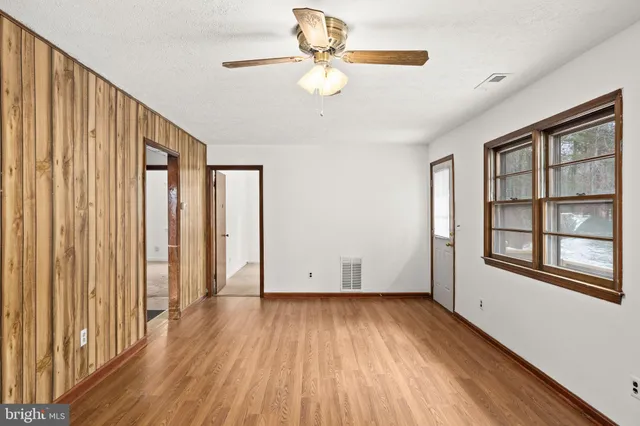 wooden floor in an empty room with a window