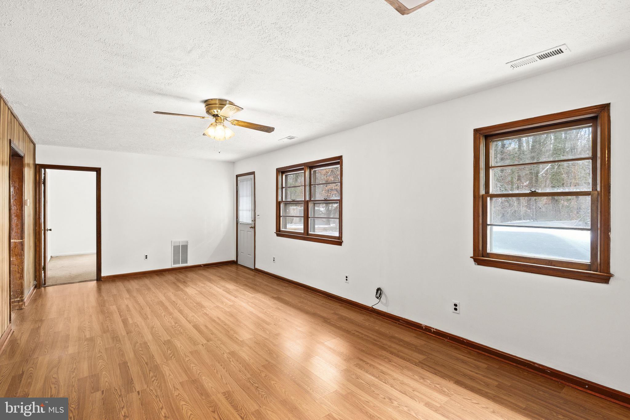 11604 Maple Tree Court Orange, VA 22960 - Photo 8 of 39 a view of an empty room with a window and wooden floor