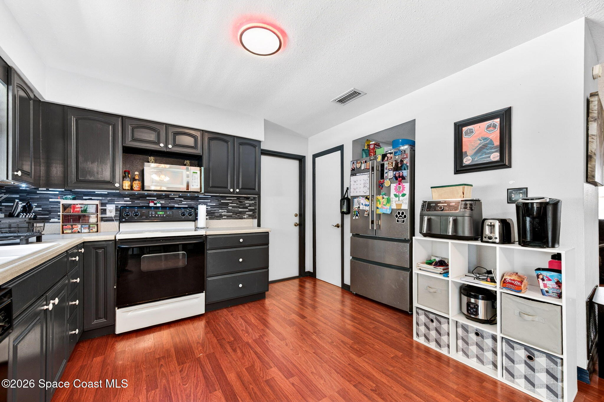 3300 Argyle Road Titusville, FL 32796 - Photo 7 of 29 a kitchen with stainless steel appliances granite countertop a refrigerator and a stove top oven