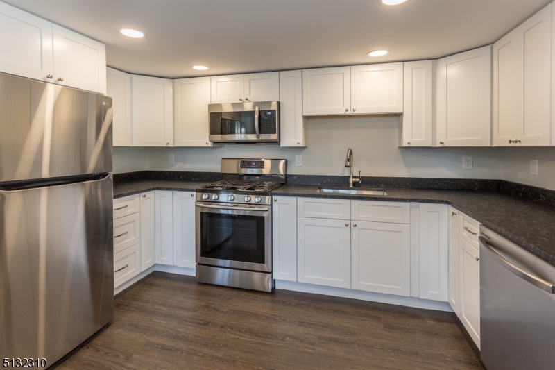 211 Washington Street, Unit 2 Hackettstown, NJ 07840 - Photo 12 of 30 a kitchen with white cabinets white stainless steel appliances and sink