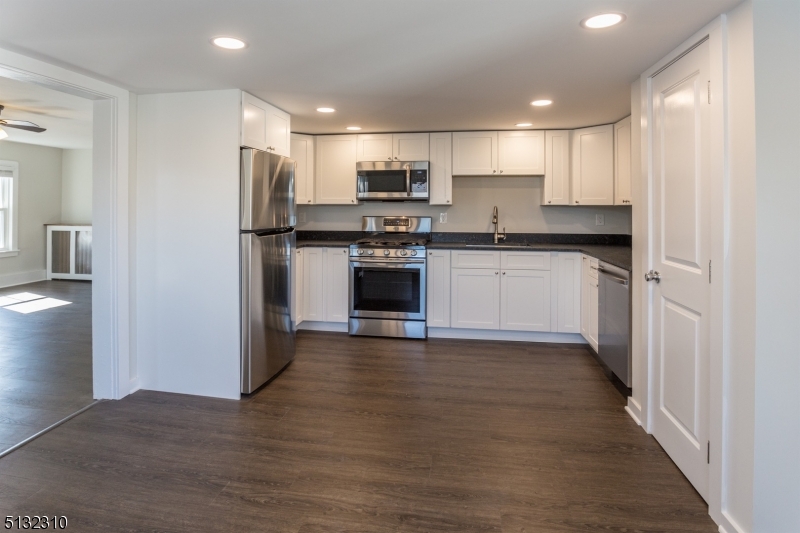 211 Washington Street, Unit 2 Hackettstown, NJ 07840 - Photo 13 of 30 a kitchen with stainless steel appliances granite countertop a refrigerator and a stove top oven