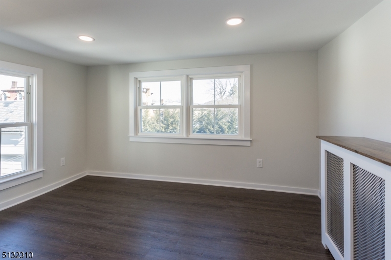 211 Washington Street, Unit 2 Hackettstown, NJ 07840 - Photo 15 of 30 a view of an empty room with wooden floor and a window