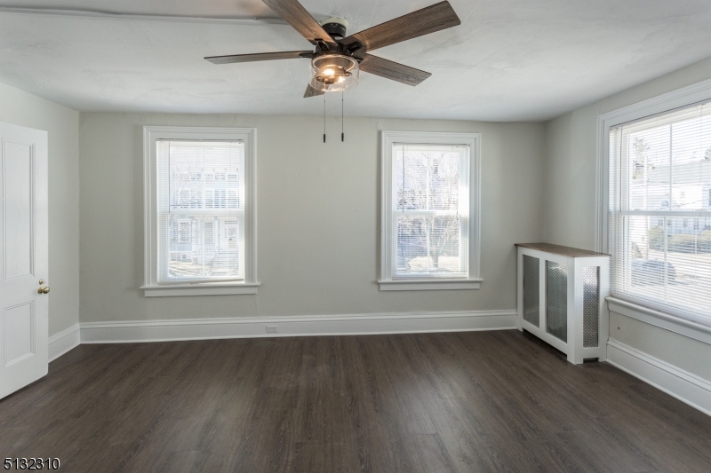 211 Washington Street, Unit 2 Hackettstown, NJ 07840 - Photo 18 of 30 a view of an empty room with a window and wooden floor