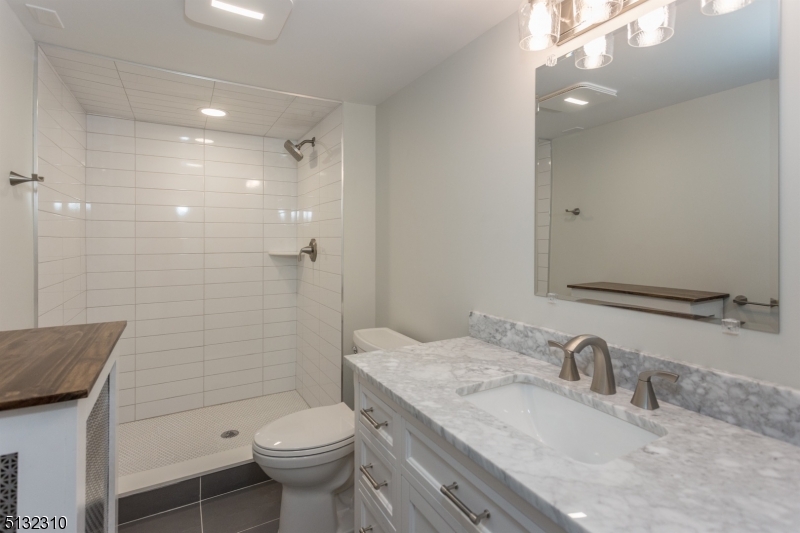 211 Washington Street, Unit 2 Hackettstown, NJ 07840 - Photo 19 of 30 a bathroom with a sink toilet and shower