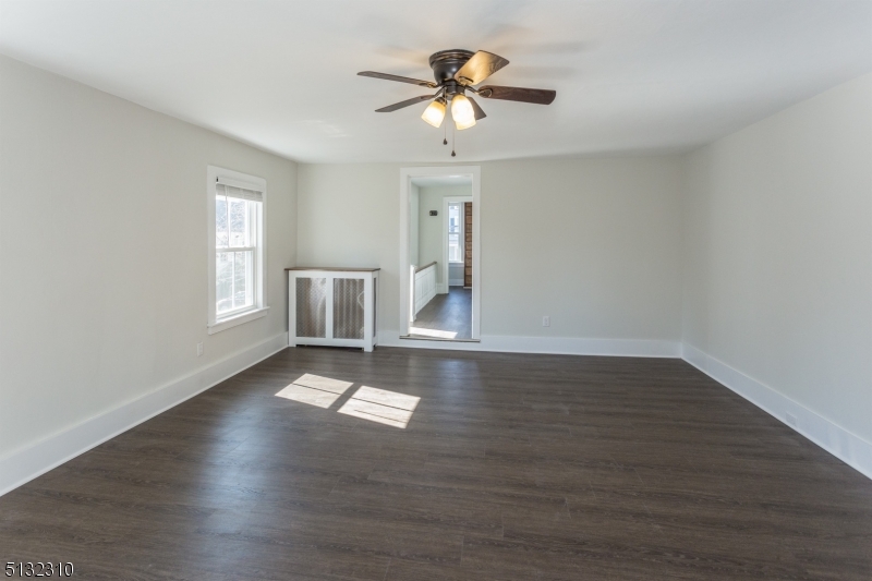 211 Washington Street, Unit 2 Hackettstown, NJ 07840 - Photo 8 of 30 a view of an empty room with window and wooden floor