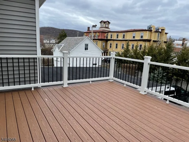 a view of a balcony with wooden floor