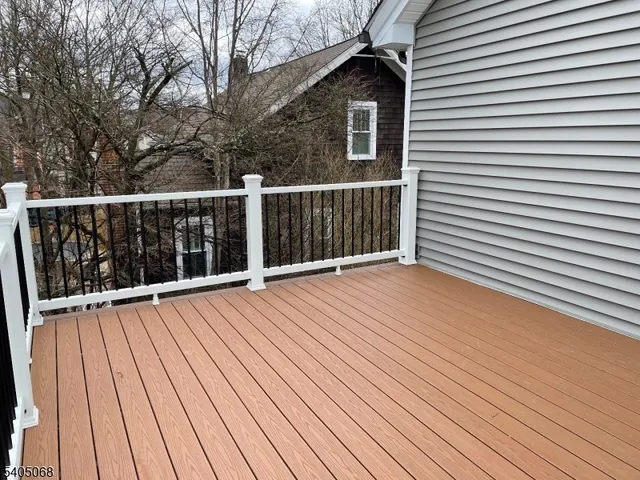 a view of backyard with a large tree