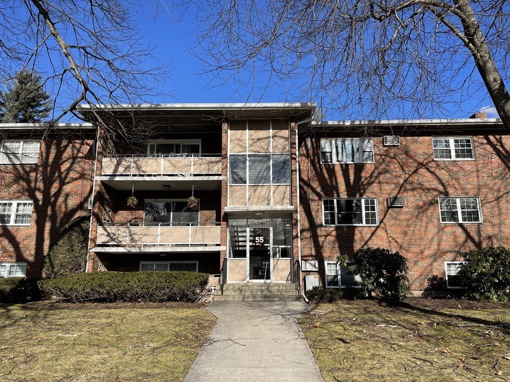 55 Jacqueline Road, Unit 7 Waltham, MA 02452 - Photo 1 of 11 a front view of a house with a yard