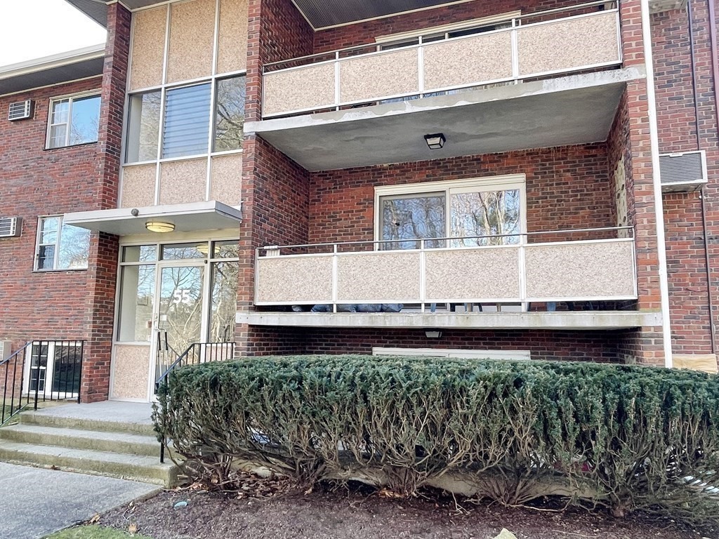 55 Jacqueline Road, Unit 7 Waltham, MA 02452 - Photo 11 of 11 a front view of a house with a garage