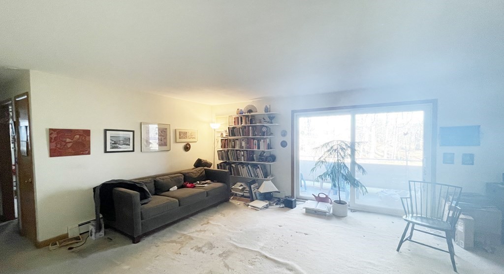 55 Jacqueline Road, Unit 7 Waltham, MA 02452 - Photo 4 of 11 a living room with furniture and a window