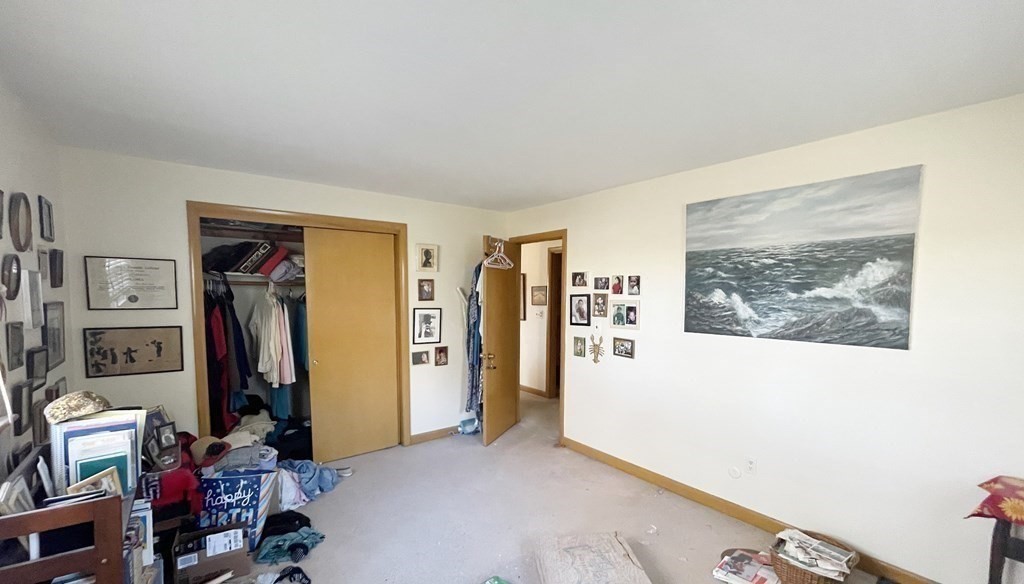 55 Jacqueline Road, Unit 7 Waltham, MA 02452 - Photo 7 of 11 a view of a livingroom with shelves